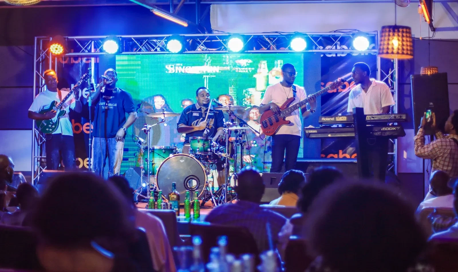 A live band performing on stage as guests watch