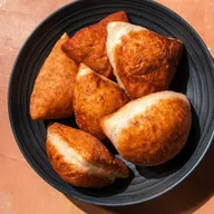 Golden fried pastries in a serving bowl