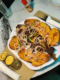 Roasted fish served with fried plantain
